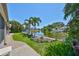 Spacious backyard with lush greenery and a beautiful pond view, enhancing the outdoor living experience at 5785 Bay Pines Lakes Blvd, St Petersburg, FL 33708