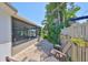 Paver patio with outdoor seating area adjacent to a serene screened-in porch and lush landscaping at 5785 Bay Pines Lakes Blvd, St Petersburg, FL 33708