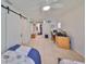 Spacious bedroom with tile floors, barn door access to a closet, and a work-from-home space at 5785 Bay Pines Lakes Blvd, St Petersburg, FL 33708