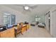 Bright bedroom with twin beds, desk, and ample natural light from shuttered window at 5785 Bay Pines Lakes Blvd, St Petersburg, FL 33708