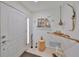 Bright foyer featuring tiled floor, white walls, and decorative elements including a shelf with avian sculptures at 5785 Bay Pines Lakes Blvd, St Petersburg, FL 33708