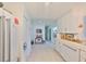 Bright kitchen offers modern appliances, white cabinetry, and ample counter space for cooking and preparing meals at 5785 Bay Pines Lakes Blvd, St Petersburg, FL 33708