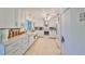 Clean kitchen showcases white cabinetry, a modern range hood, and matching appliances, offering ample countertop space at 5785 Bay Pines Lakes Blvd, St Petersburg, FL 33708