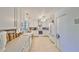 Well-lit kitchen with white cabinets, stainless steel hood, and modern appliances, designed for cooking convenience at 5785 Bay Pines Lakes Blvd, St Petersburg, FL 33708