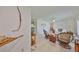 Bright living room with neutral tile floors, ceiling fan, and decorative natural accents at 5785 Bay Pines Lakes Blvd, St Petersburg, FL 33708