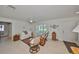 Living room featuring neutral tones, ceiling fan, tiled floors and natural light from shuttered windows at 5785 Bay Pines Lakes Blvd, St Petersburg, FL 33708