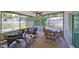 Relaxing screened-in patio with ceiling fan, comfortable seating, and tranquil pond view at 5785 Bay Pines Lakes Blvd, St Petersburg, FL 33708