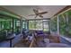 Comfortable screened-in patio with pond views, ceiling fan, and a seating area for relaxation at 5785 Bay Pines Lakes Blvd, St Petersburg, FL 33708