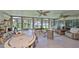 Spacious sunroom boasts panoramic windows, tile flooring, and multiple seating areas, ideal for relaxation and enjoyment at 5785 Bay Pines Lakes Blvd, St Petersburg, FL 33708