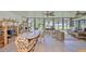 Bright sunroom with panoramic windows, tile flooring, and comfortable seating perfect for relaxing and entertaining at 5785 Bay Pines Lakes Blvd, St Petersburg, FL 33708