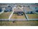 Aerial view showcasing a backyard with a screened patio, surrounded by a pristine white fence at 588 Olive Conch St, Ruskin, FL 33570