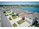 Aerial view of several homes and lake with fountain in a suburban neighborhood at 588 Olive Conch St, Ruskin, FL 33570