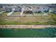 Aerial view of a home with fenced yard backing to green space with waterfront views at 588 Olive Conch St, Ruskin, FL 33570