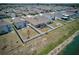 Aerial view of a home with fenced yard backing to green space and lake at 588 Olive Conch St, Ruskin, FL 33570