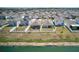 Aerial view of a home with fenced yard backing to green space and lake at 588 Olive Conch St, Ruskin, FL 33570