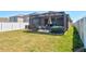 Spacious backyard featuring a screened-in patio, hot tub, and a well-maintained lawn at 588 Olive Conch St, Ruskin, FL 33570