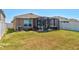 Well-maintained backyard featuring a screened-in patio with comfortable seating and a hot tub at 588 Olive Conch St, Ruskin, FL 33570