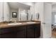 Bathroom features a double sink vanity with large mirror and a view of the toilet and shower at 588 Olive Conch St, Ruskin, FL 33570