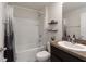 Bathroom featuring a shower-tub combination, a toilet, and a vanity with open shelving and decorative items at 588 Olive Conch St, Ruskin, FL 33570