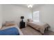Bedroom featuring two twin beds, a ceiling fan, carpet, and a window with blinds for natural light at 588 Olive Conch St, Ruskin, FL 33570