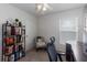 Bedroom with carpet, ceiling fan, window with blinds, chair, and a bookcase filled with books at 588 Olive Conch St, Ruskin, FL 33570