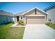 Charming single-Gathering home featuring a two-car garage and manicured front lawn at 588 Olive Conch St, Ruskin, FL 33570