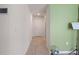Bright hallway with tile floors, neutral paint, and a view of the interior at 588 Olive Conch St, Ruskin, FL 33570