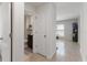 Hallway view leading to a bathroom with vanity and toilet, and a brightly lit living area at 588 Olive Conch St, Ruskin, FL 33570