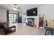 Bright living room with a decorative fireplace, tile floors, and views of the patio at 588 Olive Conch St, Ruskin, FL 33570