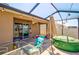 View of screened patio featuring a spa and outdoor seating, perfect for outdoor enjoyment at 588 Olive Conch St, Ruskin, FL 33570