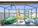 Screened patio with seating and an inflatable hot tub, offering a relaxing outdoor living space at 588 Olive Conch St, Ruskin, FL 33570