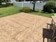 Tiled backyard patio with well-manicured lawn and white fence providing privacy and a tranquil outdoor space at 5920 30Th S Ct, St Petersburg, FL 33712