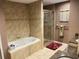 Bathroom featuring a tiled shower, soaking tub, and double vanities at 5920 30Th S Ct, St Petersburg, FL 33712