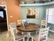 Cozy dining area featuring a round table with chairs, art on the walls, and neutral decor at 5920 30Th S Ct, St Petersburg, FL 33712