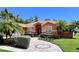 Inviting home exterior with manicured landscaping, circular driveway, and a well-maintained lawn at 5920 30Th S Ct, St Petersburg, FL 33712