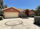 Charming single-story home featuring a circular paved driveway and lush landscaping at 5920 30Th S Ct, St Petersburg, FL 33712