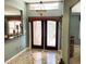 Inviting foyer with decorative glass double doors, chandelier, and tile flooring at 5920 30Th S Ct, St Petersburg, FL 33712