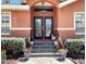 Charming front entrance with well-maintained landscaping, steps leading to the door, and an address plaque at 5920 30Th S Ct, St Petersburg, FL 33712