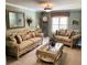 Elegant living room featuring classic furnishings, including sofas, a glass coffee table, and a decorative mirror at 5920 30Th S Ct, St Petersburg, FL 33712