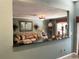 Elegant living room featuring classic furnishings, including sofas, a glass coffee table, and a decorative mirror at 5920 30Th S Ct, St Petersburg, FL 33712