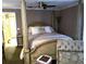 Comfortable main bedroom showcasing a four-poster bed, ceiling fan, and neutral decor at 5920 30Th S Ct, St Petersburg, FL 33712