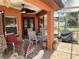Screened in patio showcasing a fan, grill, tile floor, and plenty of outdoor seating for relaxation and entertaining at 5920 30Th S Ct, St Petersburg, FL 33712