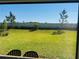 Spacious backyard with a privacy fence, seen from the covered patio with outdoor seating at 5981 Shorebird Br, Land O Lakes, FL 34638