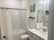 Clean bathroom featuring a shower-tub combo with white tile and vanity at 5981 Shorebird Br, Land O Lakes, FL 34638