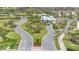 Aerial view of the community entrance with landscaped islands and gated access at 5981 Shorebird Br, Land O Lakes, FL 34638