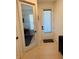 Neutral hallway featuring a study and a door to the exterior at 5981 Shorebird Br, Land O Lakes, FL 34638