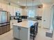 Bright kitchen with stainless steel appliances, a center island, and pendant lighting at 5981 Shorebird Br, Land O Lakes, FL 34638