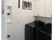 Well-equipped laundry room with modern appliances and white cabinetry at 5981 Shorebird Br, Land O Lakes, FL 34638