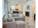 Open-concept living room features a large sectional couch and connects to the kitchen and dining areas at 5981 Shorebird Br, Land O Lakes, FL 34638