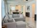 Bright open-concept living room featuring a comfortable sectional sofa and seamless flow to the dining area and kitchen at 5981 Shorebird Br, Land O Lakes, FL 34638